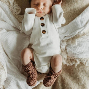 Newborn baby wearing baby booties