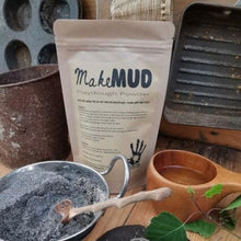 Load image into Gallery viewer, Mud Playdough Powder sachet in a mud kitchen.
