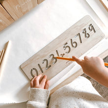 Load image into Gallery viewer, Kids tracing a Numbers 0-9 Wooden Tracing Board with a pencil. 