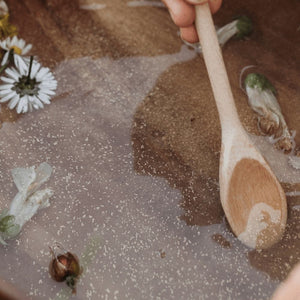 wooden-spoon-mixing-eco-glitter-in-water