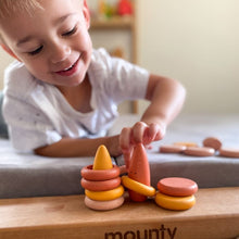Load image into Gallery viewer, Little boy playing with wooden loose parts.