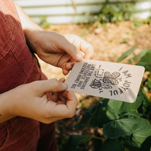 Load image into Gallery viewer, Girl in the garden holding an I am Joyful Affirmation Card.
