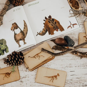 open-dinosaur-book-with-wooden-engraved-tiles-of-dinosaurs