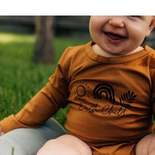 Load image into Gallery viewer, baby sitting outside wearing an earth child romper
