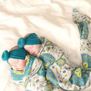 newborn baby girls wrapped in a swaddle