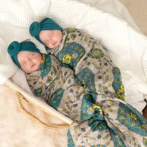 twin baby girls in a turban headband and baby wrap