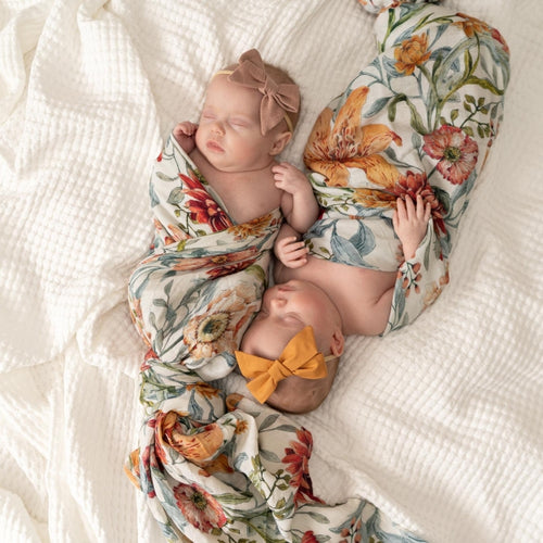 twin-baby-girls-asleep-wrapped-in-floral-wraps