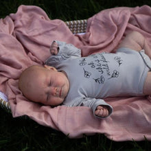 Load image into Gallery viewer, baby-girl-in-wildflower-fluttersuit-lying-on-a-pink-blanket-in-a-basket
