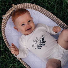 Load image into Gallery viewer, ginger-haired-baby-lying-outside-on-grass-in-baby-basket